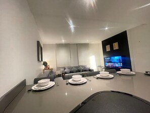 An elegant dining area adorned with modern decor, a beautiful table setting, and easy access to the kitchen for seamless entertaining.