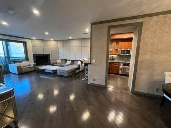 Spacious Living room! Large soft couch with large white stone coffee table.  Cozy up with a fire and enjoy youself.