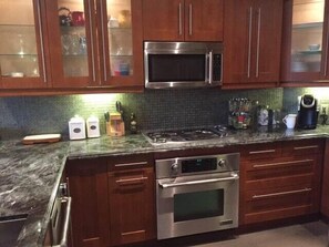 full stainless steel kitchen with everything you need to make the perfect dinner.