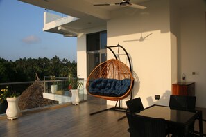 Relaxing swing on the second floor balcony, perfect for an ocean view breakfast!