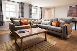 Grange House - large corner sofa and coffee table in the sitting room