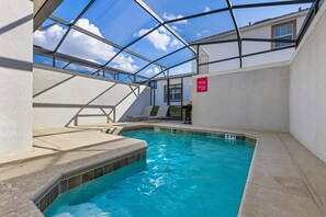 Private pool with a BBQ grill and lounge chairs