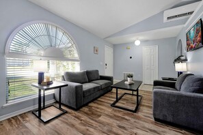 Bright front living room.  Enjoy the natural light from the large Arch window overlooking the front lawn.