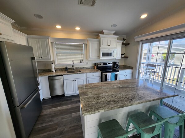 Kitchen Paradise: Sunlit space with modern appliances and a spacious island for memorable meals!