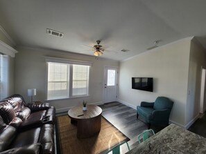 Living Room: Bright and airy space with stylish seating and a flat-screen TV for relaxation!
