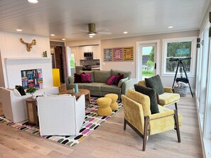 The spacious living room is open to the kitchen, dining area and 1st floor rooms