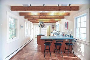 The airy kitchen offers ample space & all the comforts of home