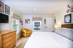 This chic king bedroom features a Smart TV & fantastic theater artwork
