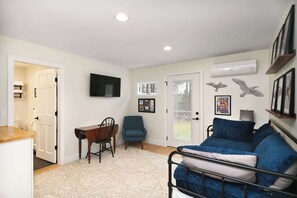 A twin daybed with twin trundle, Smart TV, & kitchenette await in this serene bedroom