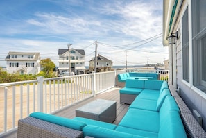 Relax on the back deck with comfy seating and a grill ready for your next cookout.