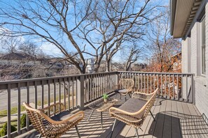 Unit A - spacious upper deck attached to Bedroom #2, equipped with outdoor furniture overlooking charming Belmont Boulevard.