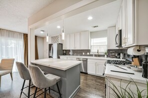 Fully equipped kitchen with modern appliances, cookware, and utensils, ready for any culinary needs.