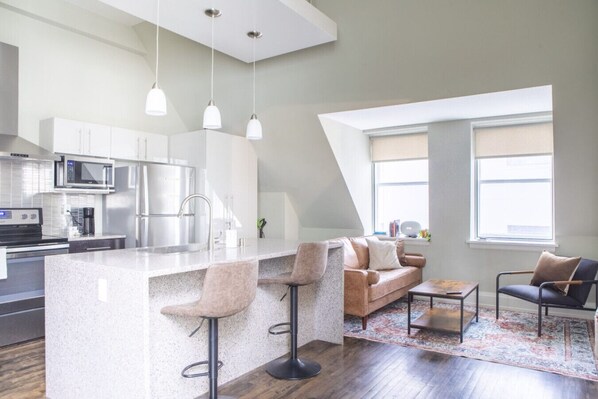 Living room and kitchen with bar stool seating