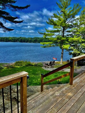 Deck has dining table, chairs and BBQ.