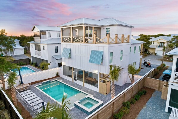 Funky Flamingo - Sleeps 28! Private gated beach access just steps away and FREE golf cart included! Private backyard oasis with heated pool, hot tub, lounge chairs, hammocks, outdoor dining table, and screened in outdoor kitchen and lounge area.