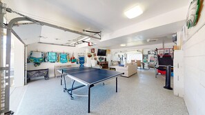 Garage converted to game room with another living room with large smart TV. 