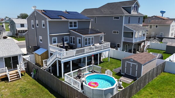 Great outdoor space with pool and upper and lower deck.