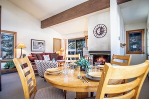 The dining room features a table that comfortably seats 4, with additional seating for 3 at the bar.