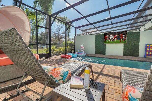Private pool with loungers, TV, and floaties. Game time!