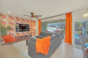 Bright and stylish lounge with TV and seamless outdoor flow.