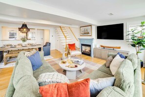 Experience the warmth and openness of the space with an inviting open floor plan, where the dining and living areas flow seamlessly together. 