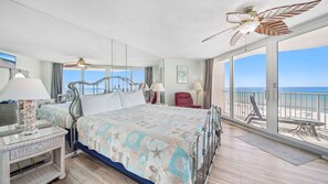 Wake up to stunning Gulf views in this coastal-inspired bedroom featuring a plush king bed and private balcony access. Relax under tropical ceiling fans and drift off to the sound of the waves.