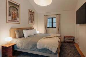 Retreat to a luxurious master bedroom featuring a sumptuous king bed and a serene, modern design.