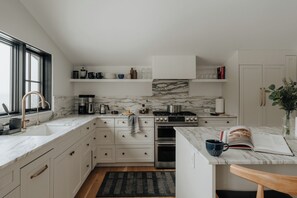 A modern kitchen outfitted with high-end appliances and elegant finishes, designed for gourmet creations.