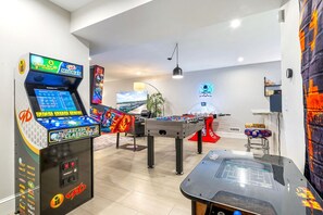 Game room with bunk bed, 6 commercial-grade arcade games, wet bar, and Xbox