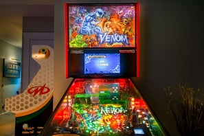 Game room with bunk bed, 6 commercial-grade arcade games, wet bar, and Xbox