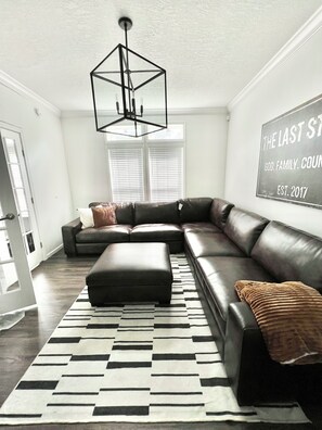 This den/tv room has a 65 inch smart tv. It's the perfect place to unwind!