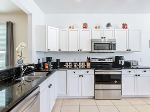 Fully-equipped kitchen with a pass-through window to the dining room