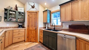 Kitchen: wood cabinets, sink. Rustic charm.