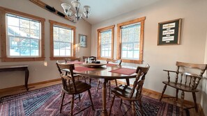 Dining room: wood table, chairs. Cozy space.
