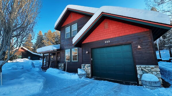 Modern house, angled roof. Snow-covered setting.