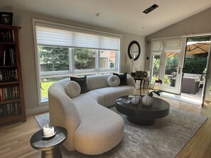Sun Room adjacent to kitchen, French Doors open to a Patio 