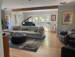 Living Room with big screen TV, Surround Sound and Baby Grand Piano