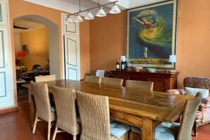 The dining room is sunny and well equipped with dish ware, platters and bowls.