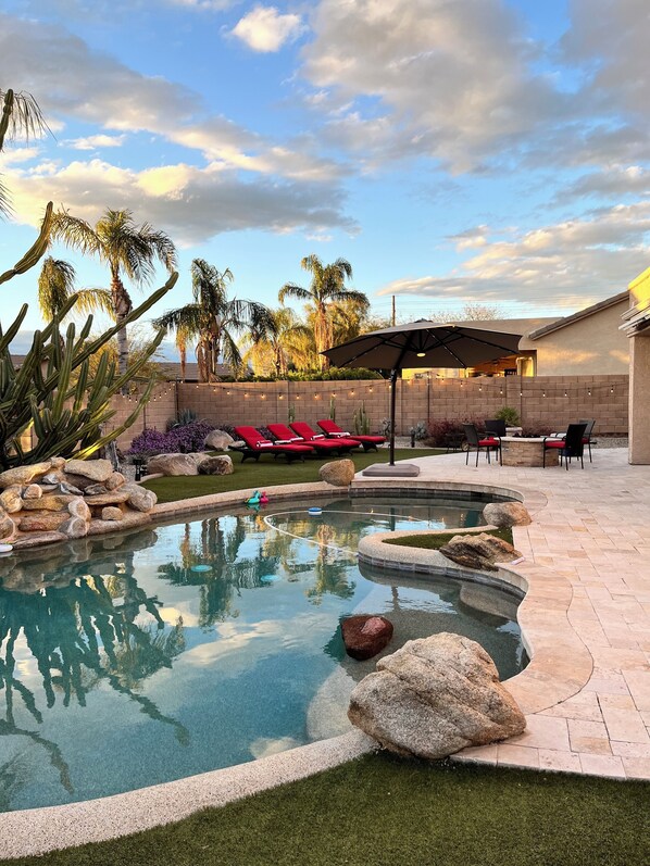 Full backyard with heated pool, awnings for shade, bbq and fire pit.