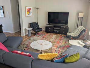 Wind-down on the modern sectional while watching the smart TV.