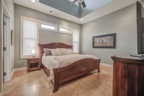 A bright, airy bedroom with elegant wooden furnishings and plenty of natural light for a relaxing retreat