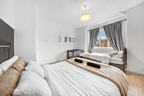 The room is filled with soft textiles, such as throw blankets and cushions, ensuring ultimate comfort and warmth.