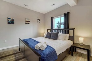 The cozy bedroom features a plush king-size bed, soft linens, and warm lighting for a restful night’s sleep.





