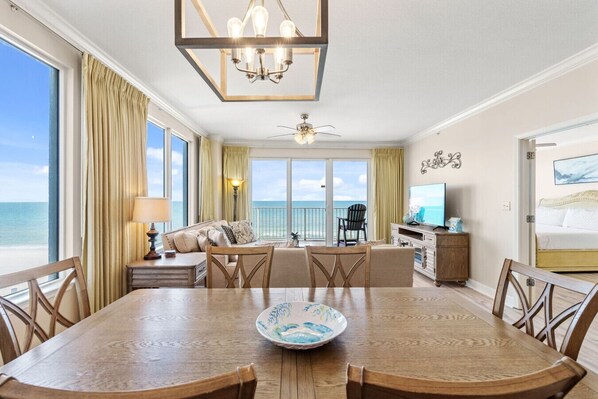 Enjoy meals with a view at the dining table, framed by floor-to-ceiling windows that showcase the breathtaking Gulf.