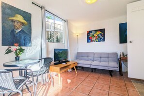 Our simple living room is a bright space, close to everything you need.