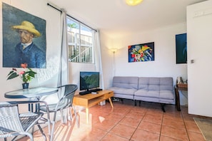 Our simple living room is a bright space, close to everything you need.
