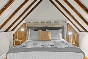 Bedroom: Comfortable bed and fluffy pillows that's best for a serene sleep.
