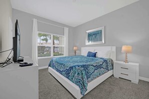 Relax in this cozy bedroom featuring vibrant decor and natural light, perfect for unwinding after a day of adventure!