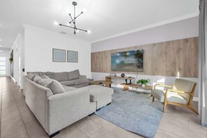 Relax in this stylish living room featuring a cozy sectional and modern decor, perfect for unwinding after a day of adventure.