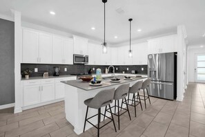 Sleek and modern kitchen with a spacious island, perfect for culinary adventures and gatherings.